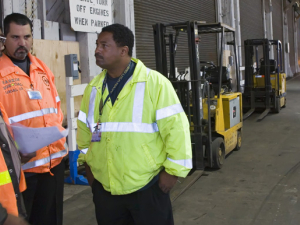 Three workers discussing workplace issues.
