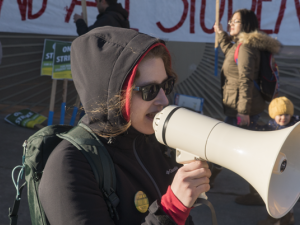 Woman on megaphone supporting Oakland teachers and students during Oakland teacher strike.