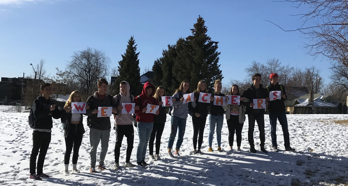 Denver students held signs spelling out "We heart teachers."