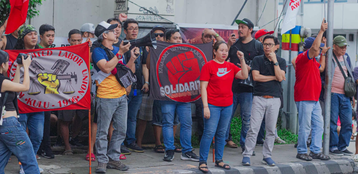 Filipino workers rally outside Kawasaki Motors.