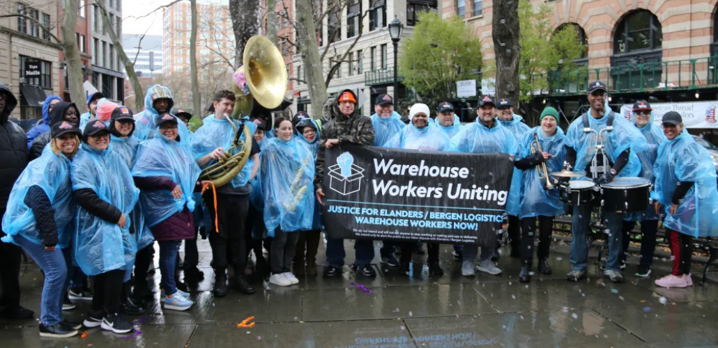 Bergen logistics workers and supporters gather in blue rain ponchos. 