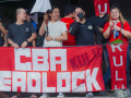Filipino workers rally behind a red banner that reads CBA Deadlock.
